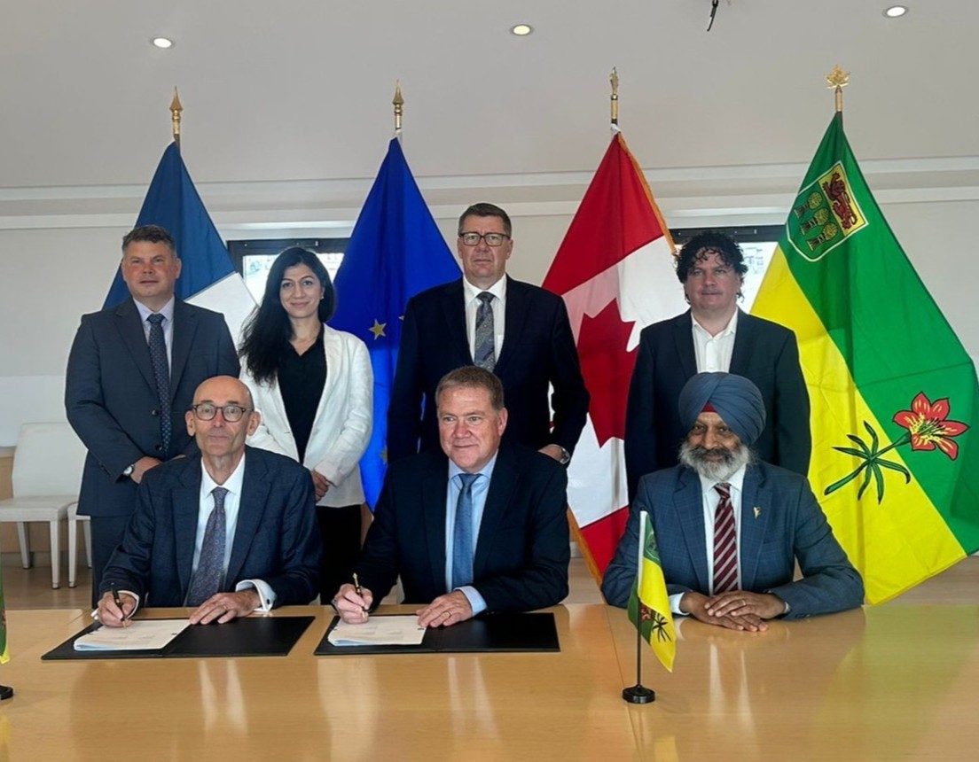 people signing document at table