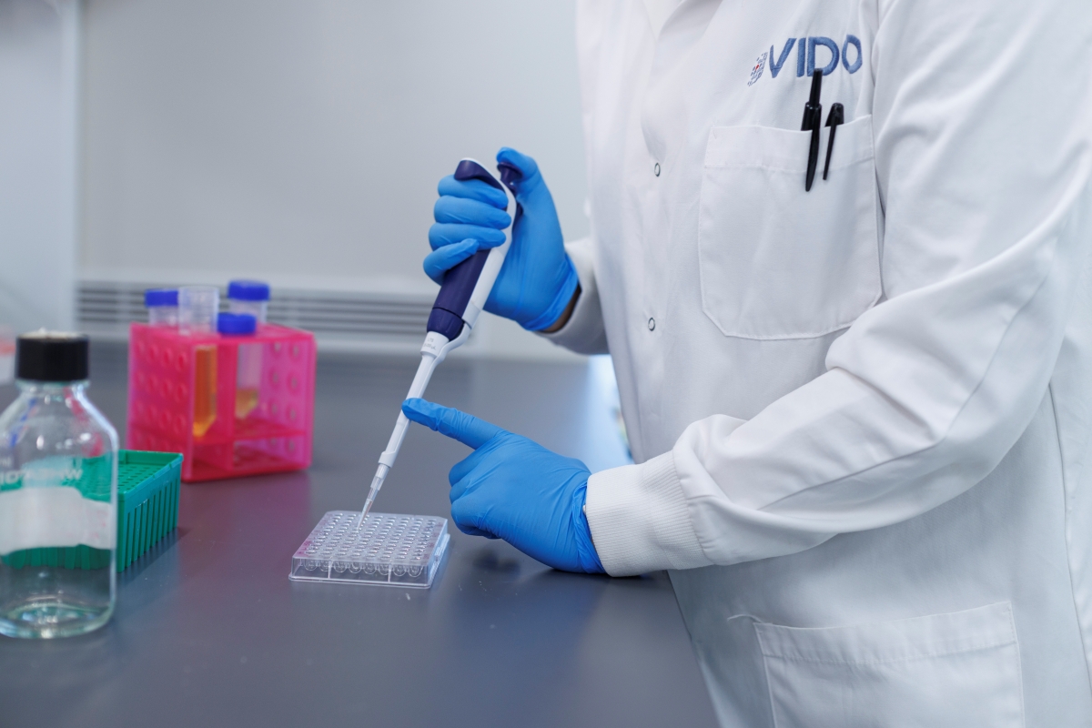 pipetting media at a bench