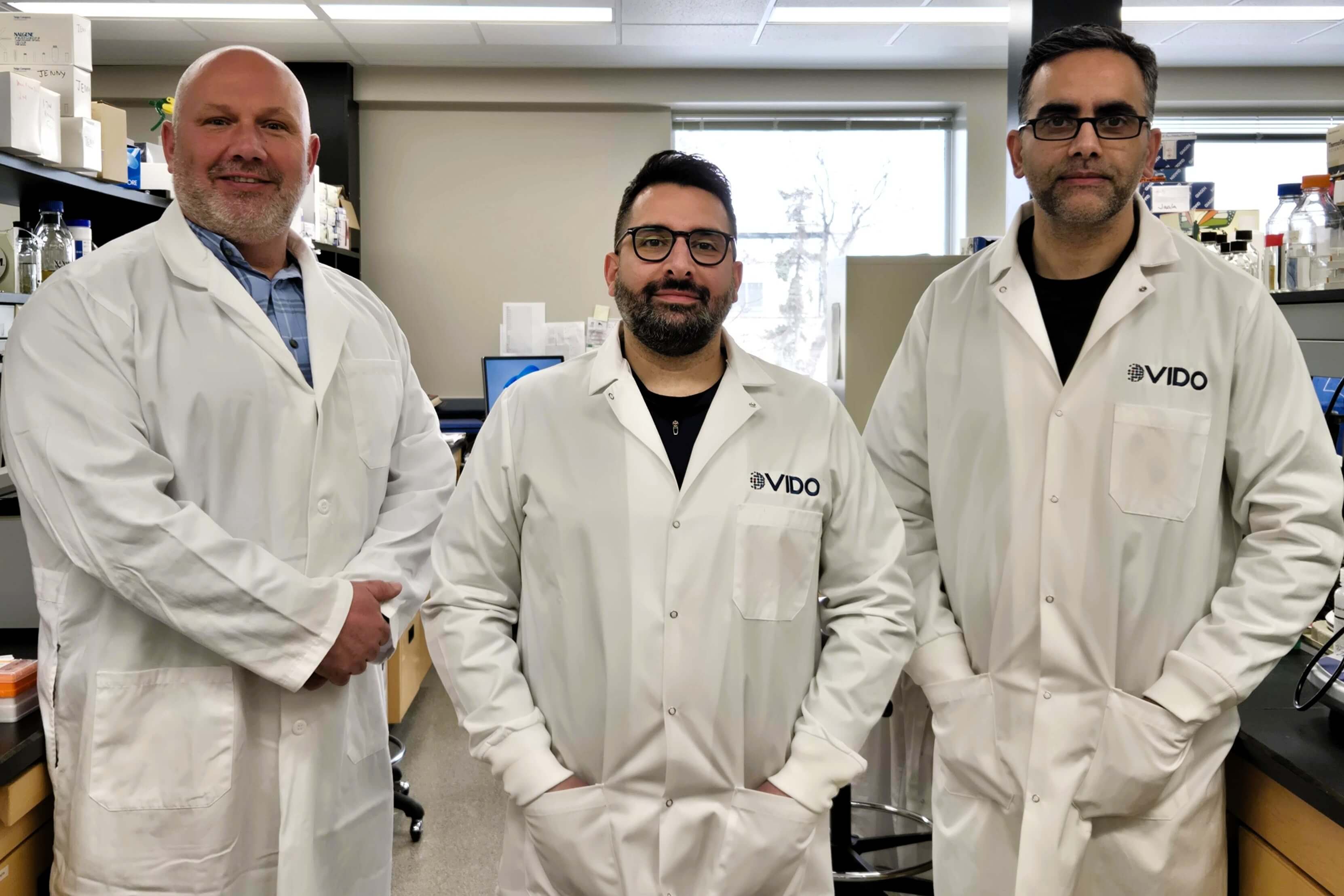 three scientists in lab coats