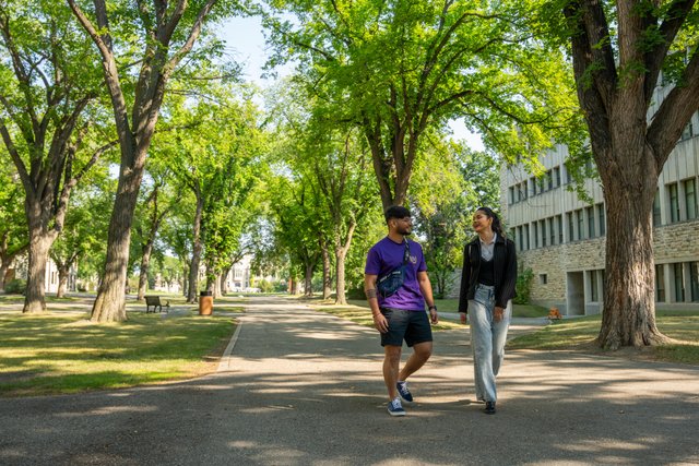two people walking on a path